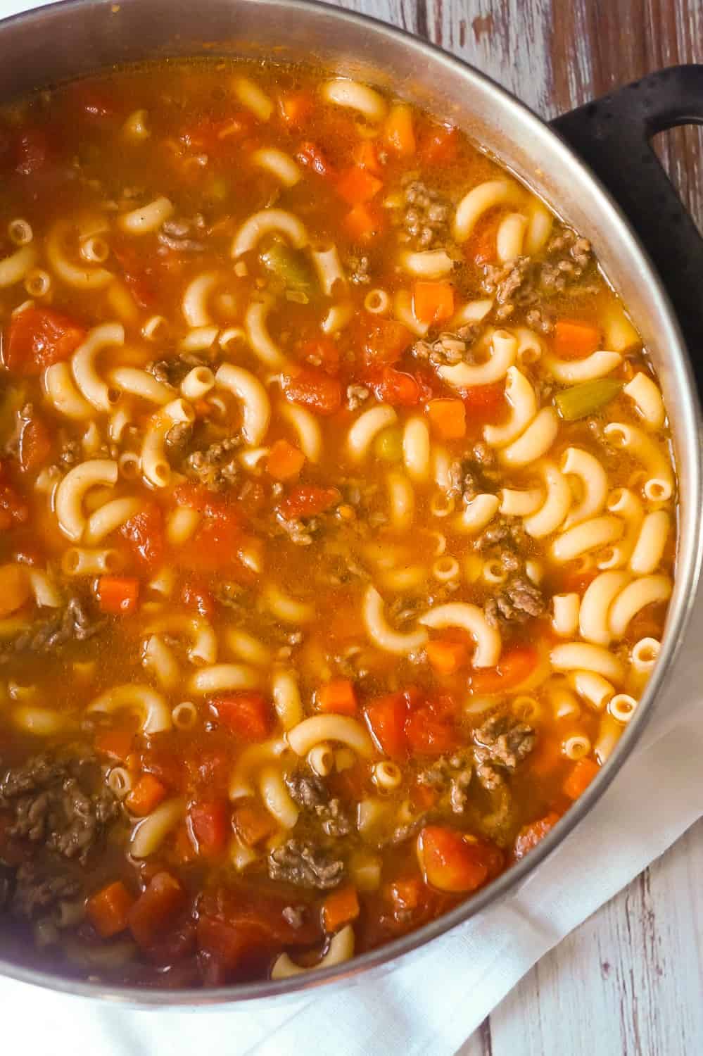 Easy Hamburger Soup with Macaroni is a hearty soup recipe that takes just fifteen minutes from start to finish.This delicious soup is loaded with ground beef, diced tomatoes, mixed vegetables and macaroni noodles.