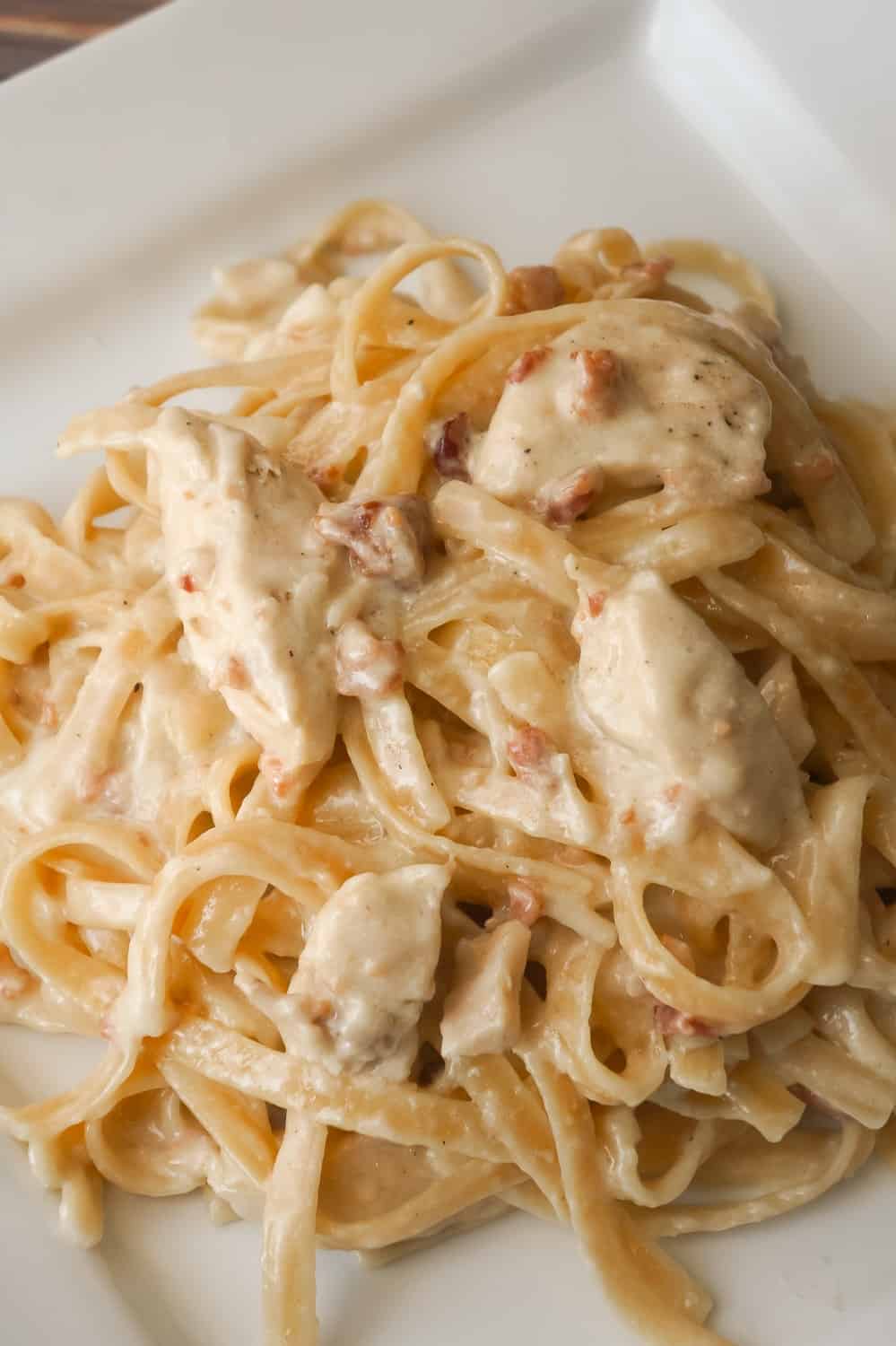 Instant Pot Bacon & Chicken Fettuccine Alfredo is an easy dinner recipe using an Instant Pot. This delicious pasta is coated in a creamy garlic Alfredo sauce and loaded with chicken and bacon.