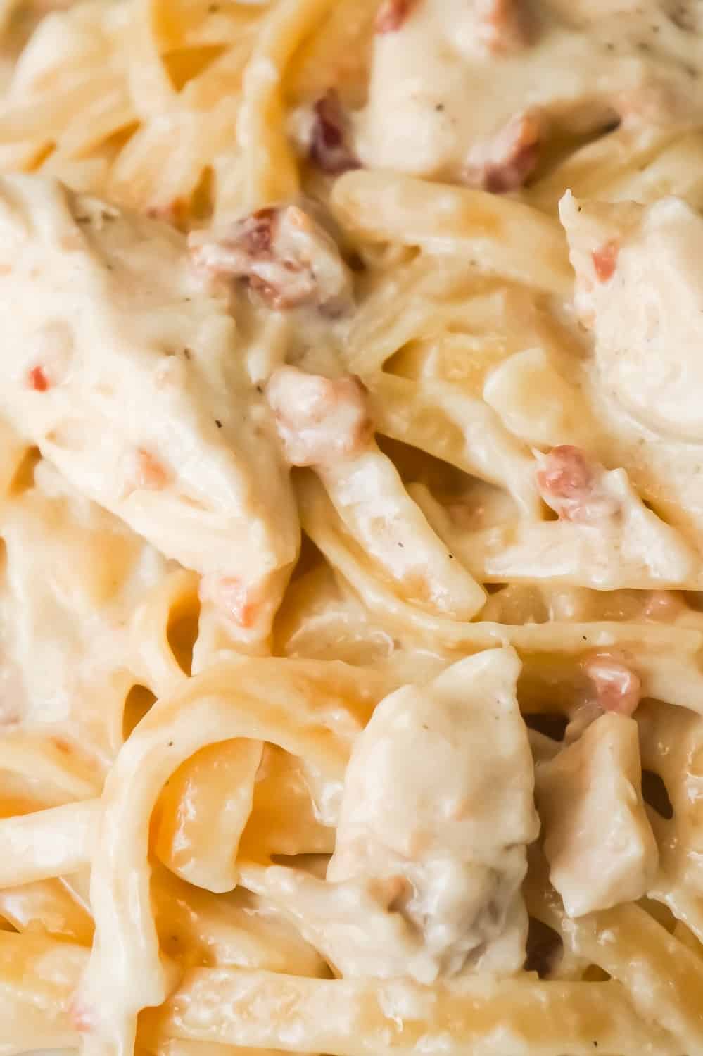 Instant Pot Bacon & Chicken Fettuccine Alfredo is an easy dinner recipe using an Instant Pot. This delicious pasta is coated in a creamy garlic Alfredo sauce and loaded with chicken and bacon.