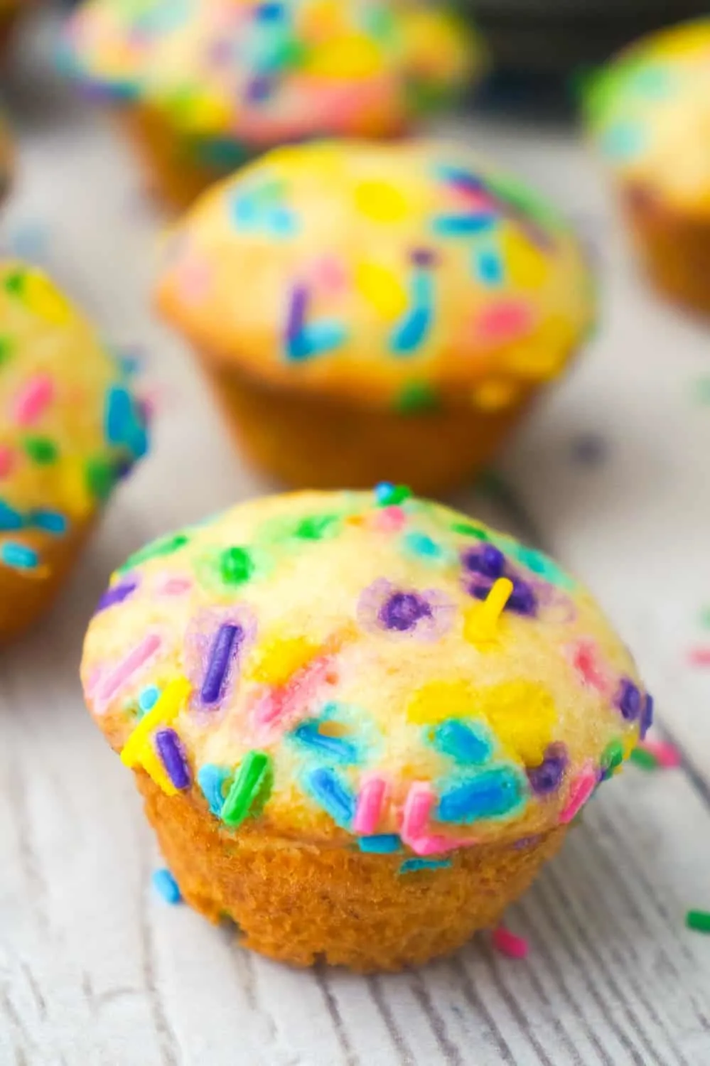 Mini Birthday Cake Banana Muffins are an easy snack or dessert your kids will love. These colourful mini muffins are made with confetti cake mix, ripe bananas and lots of sprinkles.