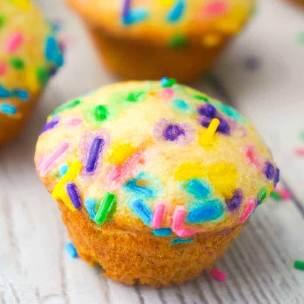 Mini Birthday Cake Banana Muffins are an easy snack or dessert your kids will love. These colourful mini muffins are made with confetti cake mix, ripe bananas and lots of sprinkles.