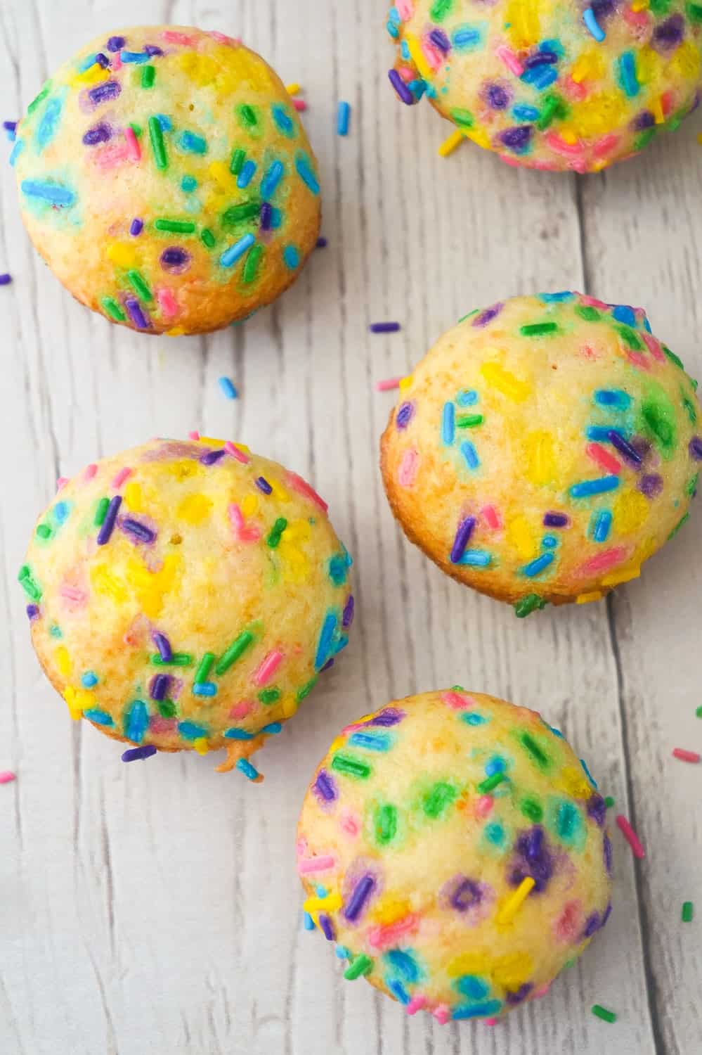 Mini Birthday Cake Banana Muffins are an easy snack or dessert your kids will love. These colourful mini muffins are made with confetti cake mix, ripe bananas and lots of sprinkles.