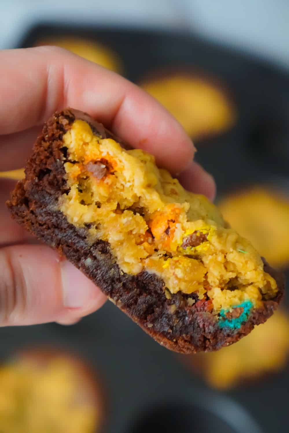Monster Cookie Brownie Cups are an easy dessert recipe using boxed brownie mix and homemade oatmeal peanut butter cookie dough. These chewy brownie cups are loaded with mini M&Ms.