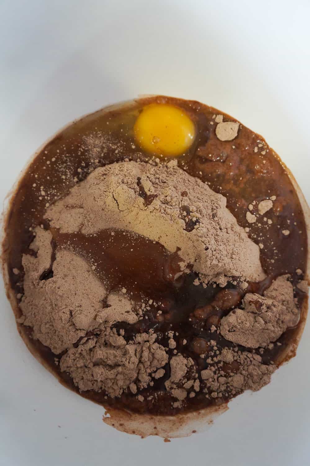 brownie mix in a bowl with eggs, oil and water