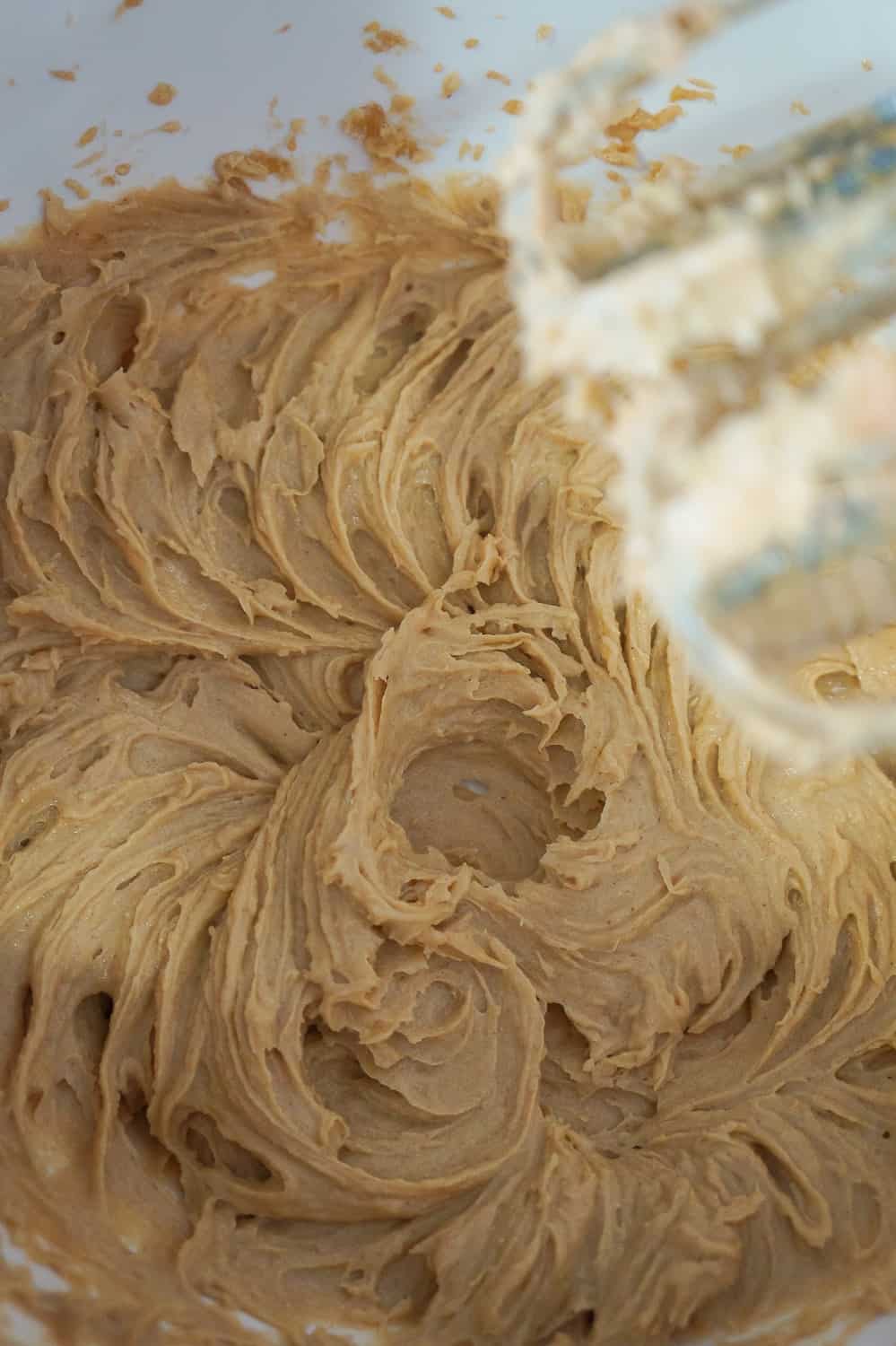 peanut butter, butter and sugar creamed together in a mixing bowl