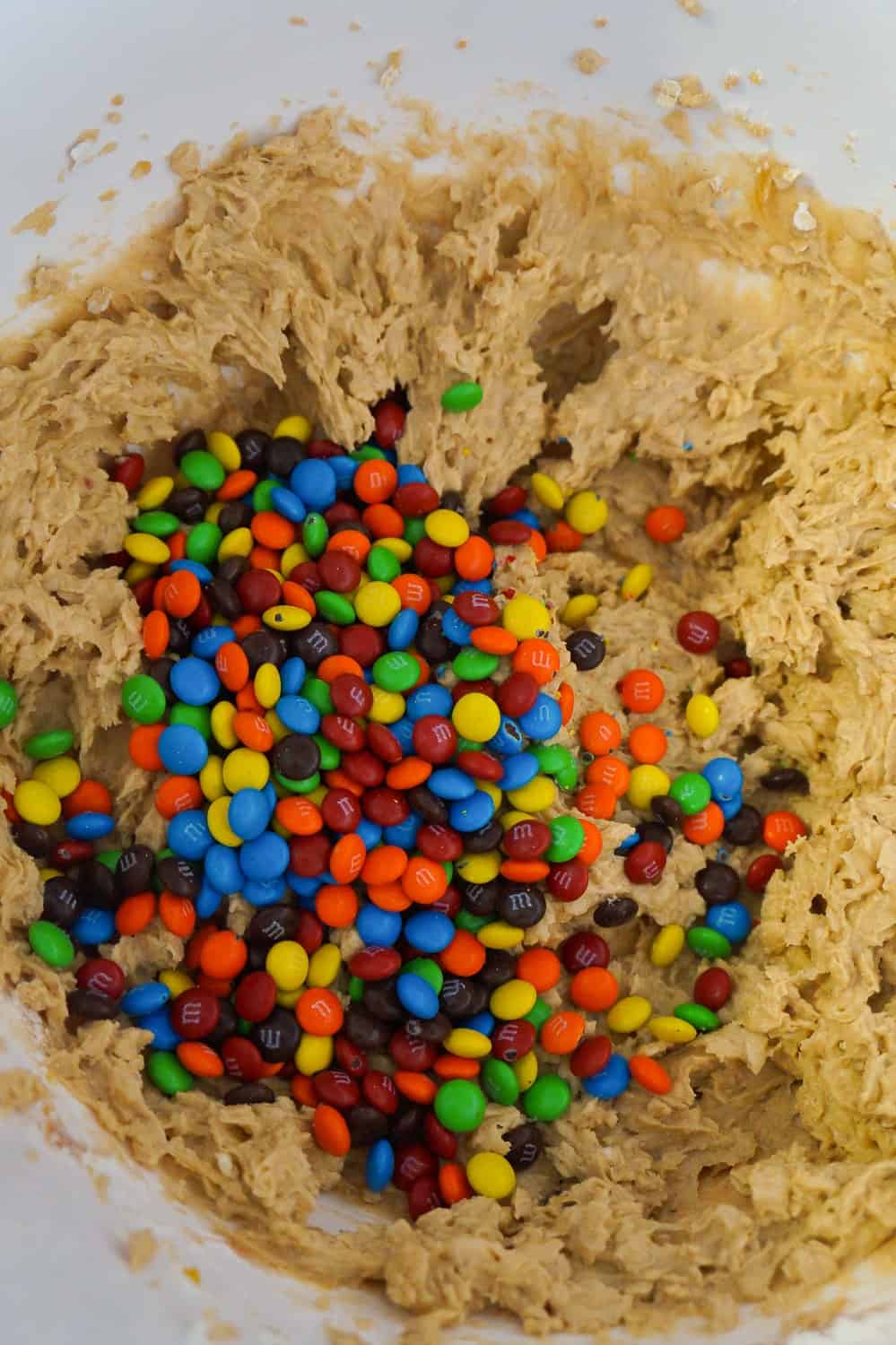 mini M&Ms on top of peanut butter oatmeal cookie dough
