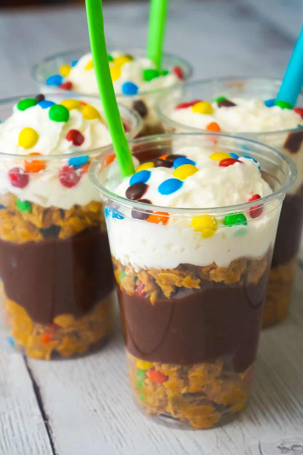 Monster Cookie Pudding Parfaits are a fun and easy no bake dessert perfect for summer. These colourful dessert cups are loaded with oatmeal peanut butter cookie dough, chocolate pudding and mini M&Ms.