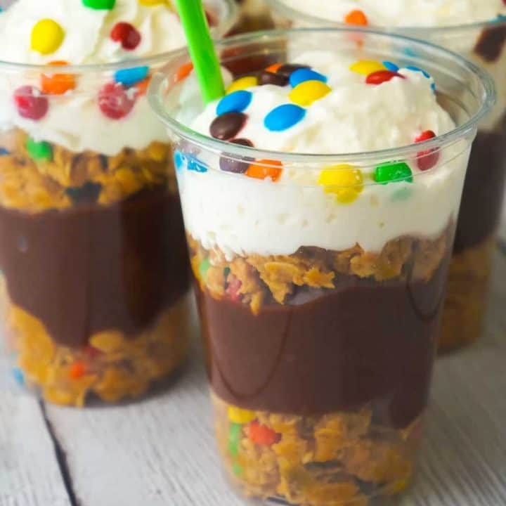 Monster Cookie Pudding Parfaits are a fun and easy no bake dessert perfect for summer. These colourful dessert cups are loaded with oatmeal peanut butter cookie dough, chocolate pudding and mini M&Ms.