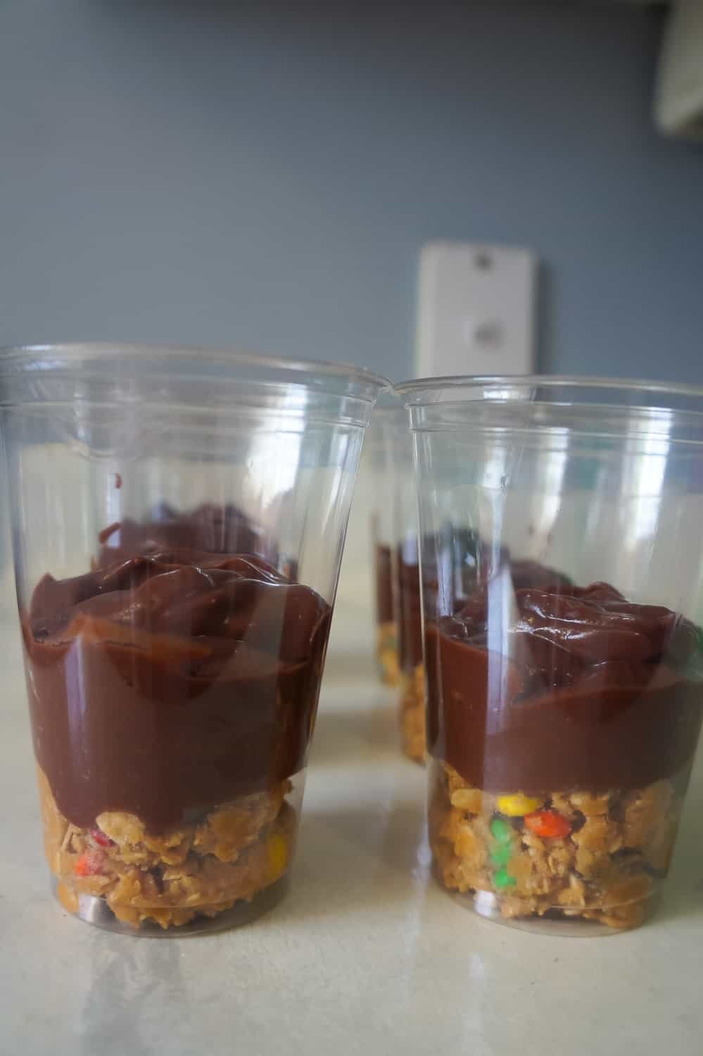 monster cookie dough and chocolate pudding in plastic cups