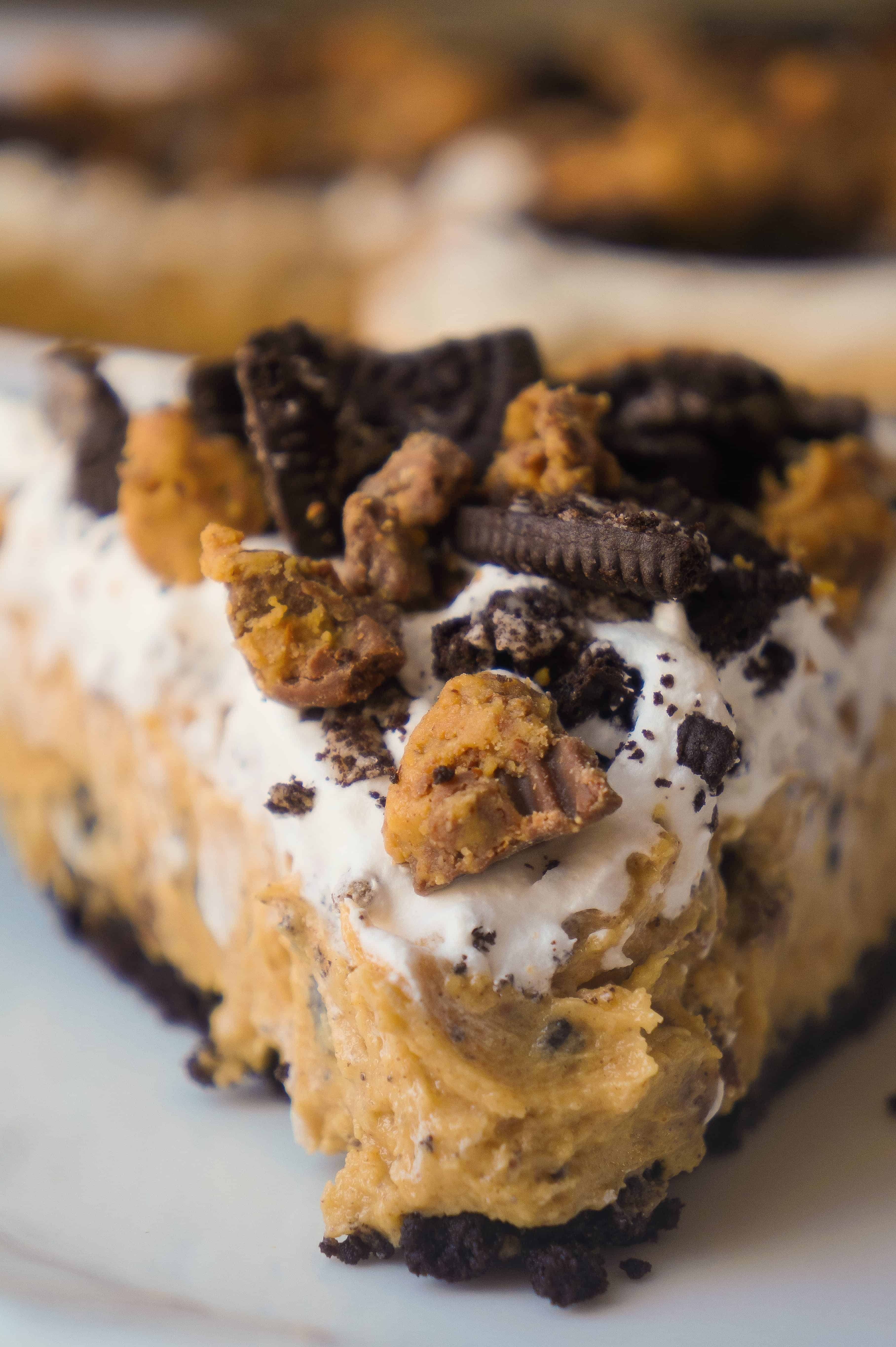 No Bake Oreo Peanut Butter Cup Cheesecake is a quick and easy dessert recipe perfect for any occasion. An Oreo cookie pie crust is filled with a delicious peanut butter and cream cheese mixture loaded with pieces of Reese's Peanut Butter Cups and Oreo cookies. This chocolate peanut butter dessert is perfect for summer.