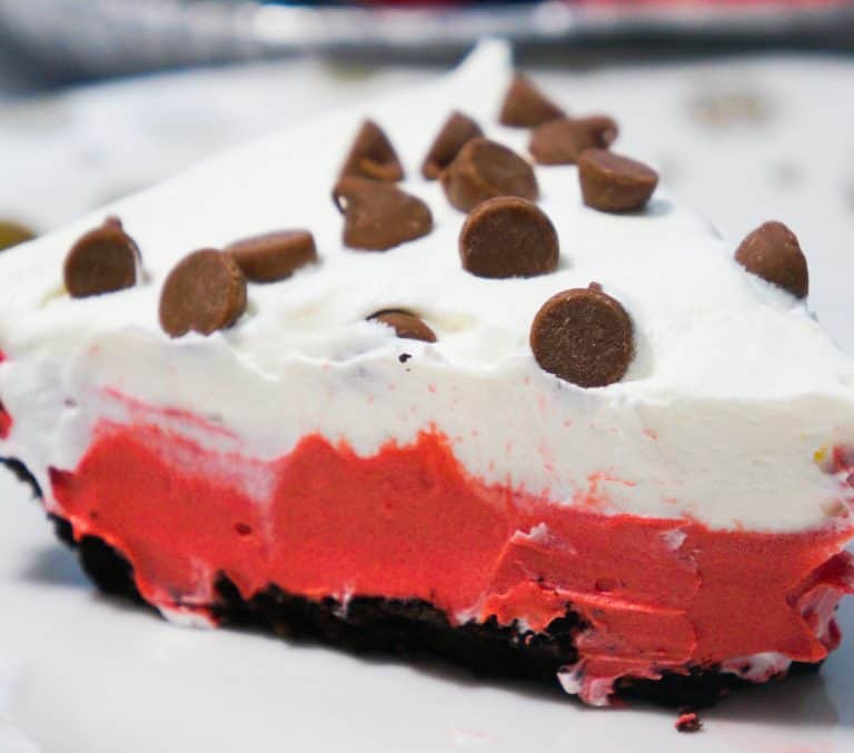 Slice of no bake red velvet pie with Oreo crust.