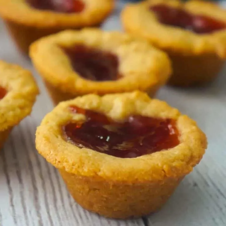 Peanut Butter and Jelly Blondie Bites are a delicious bite sized dessert baked in mini muffin tins. These peanut butter blondies are topped with strawberry jam and baked to perfection.
