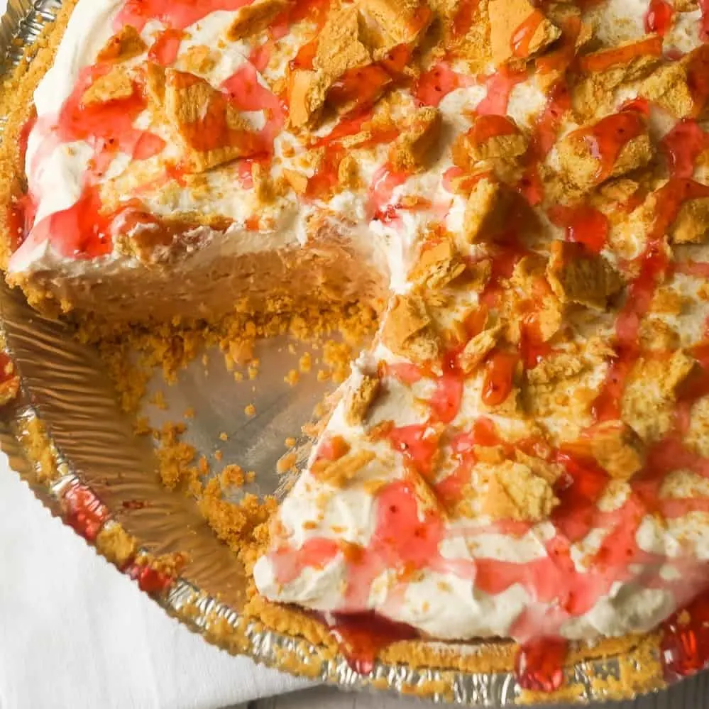 Peanut Butter and Jelly No Bake Cheesecake is an easy dessert recipe perfect for summer. The graham cracker crust is filled with a smooth and creamy PB & J filling that will remind you of the classic sandwich from your childhood.