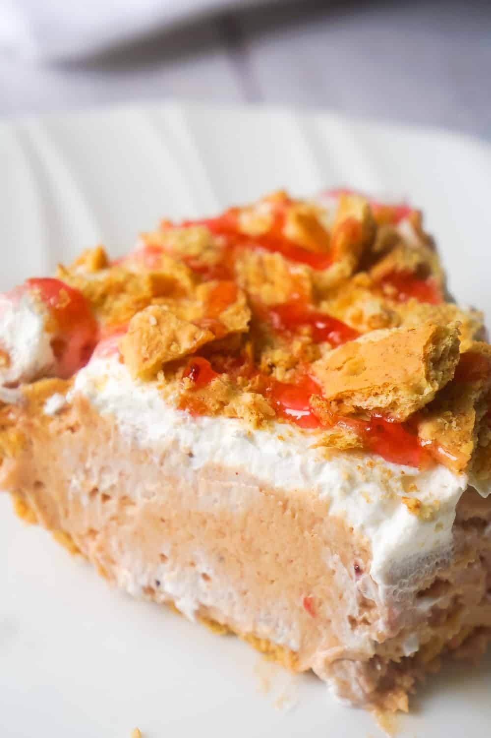 Peanut Butter and Jelly No Bake Cheesecake is an easy dessert recipe perfect for summer. The graham cracker crust is filled with a smooth and creamy PB & J filling that will remind you of the classic sandwich from your childhood.
