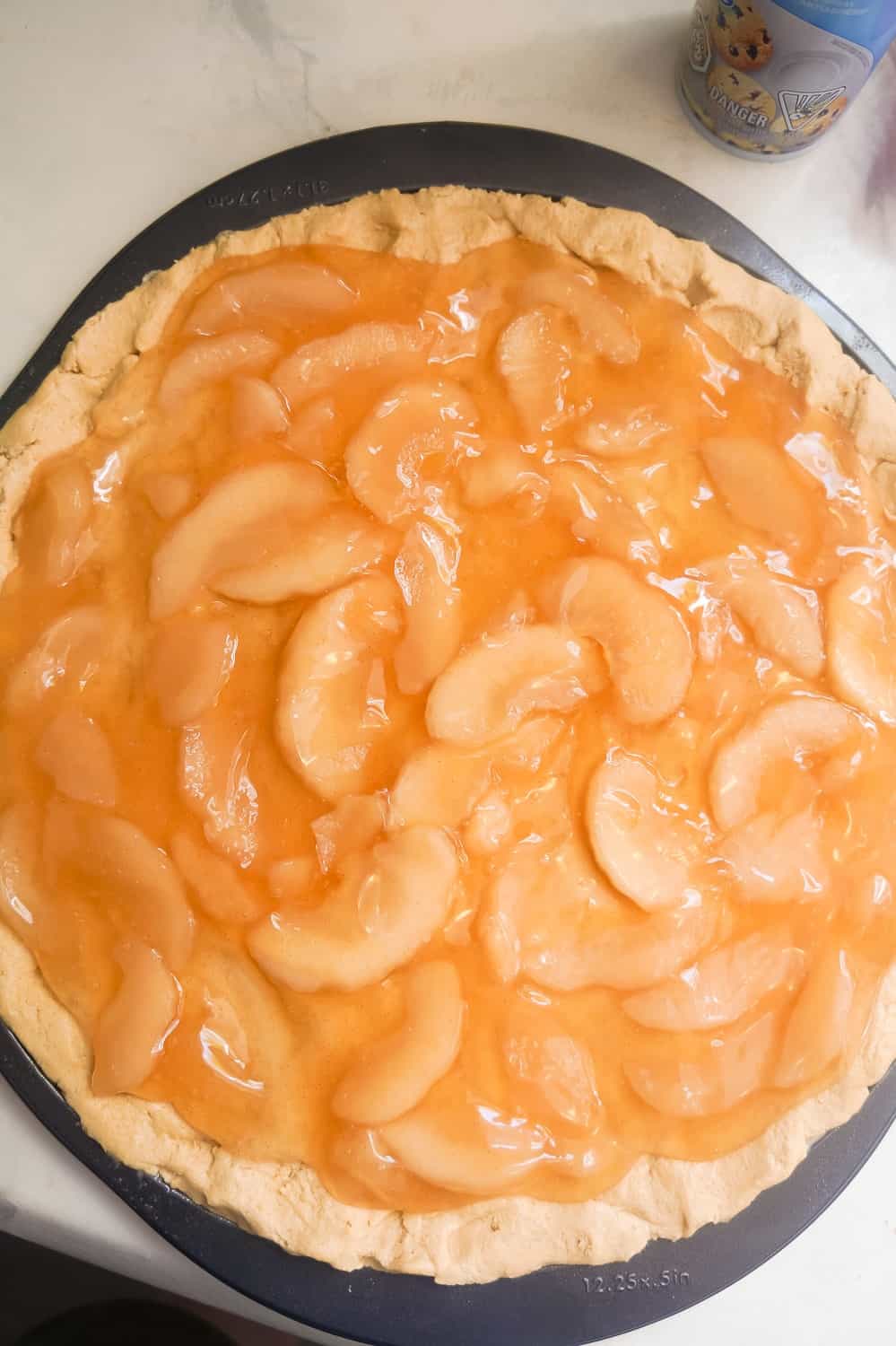 apple pie filling spread over peanut butter cookie dough