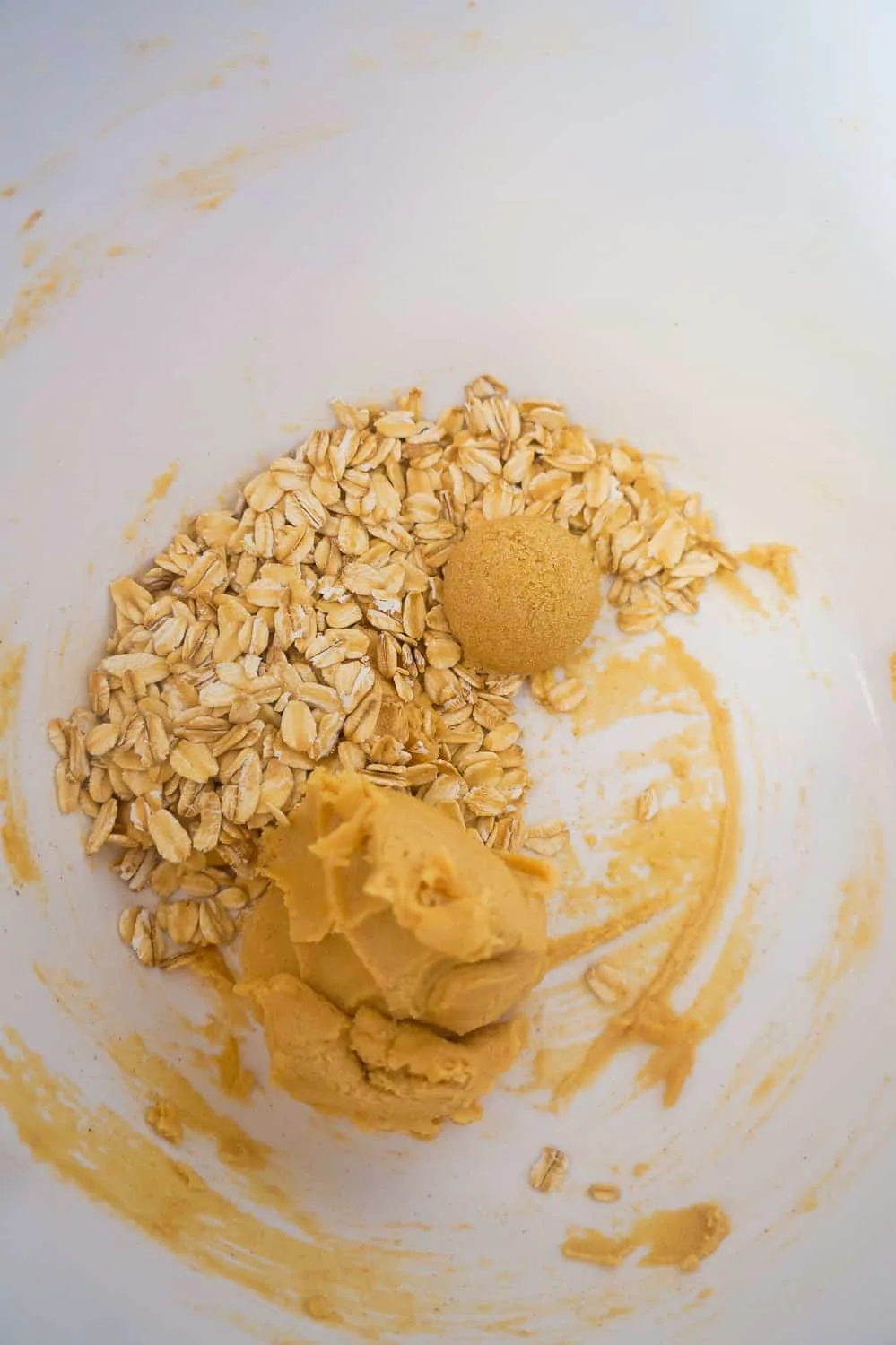 peanut butter cookie dough, oats and brown sugar in a mixing bowl