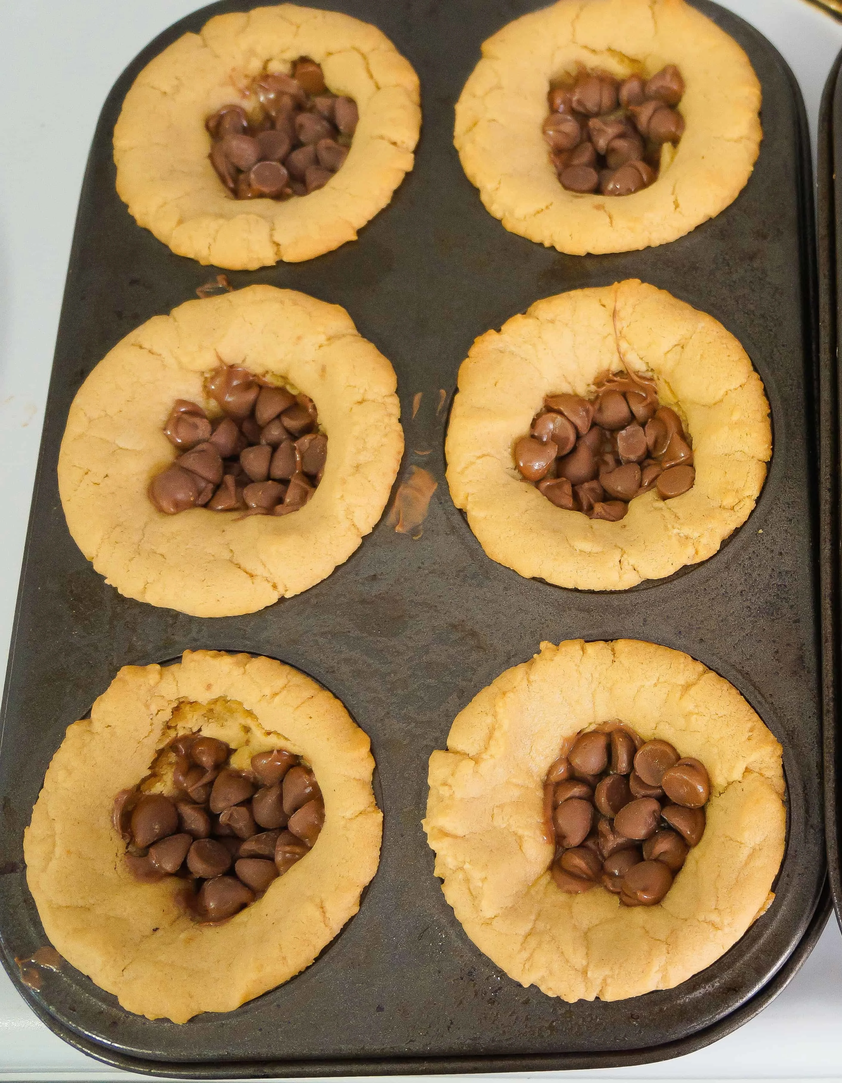 peanut butter cookie cups filled with chocolate chips