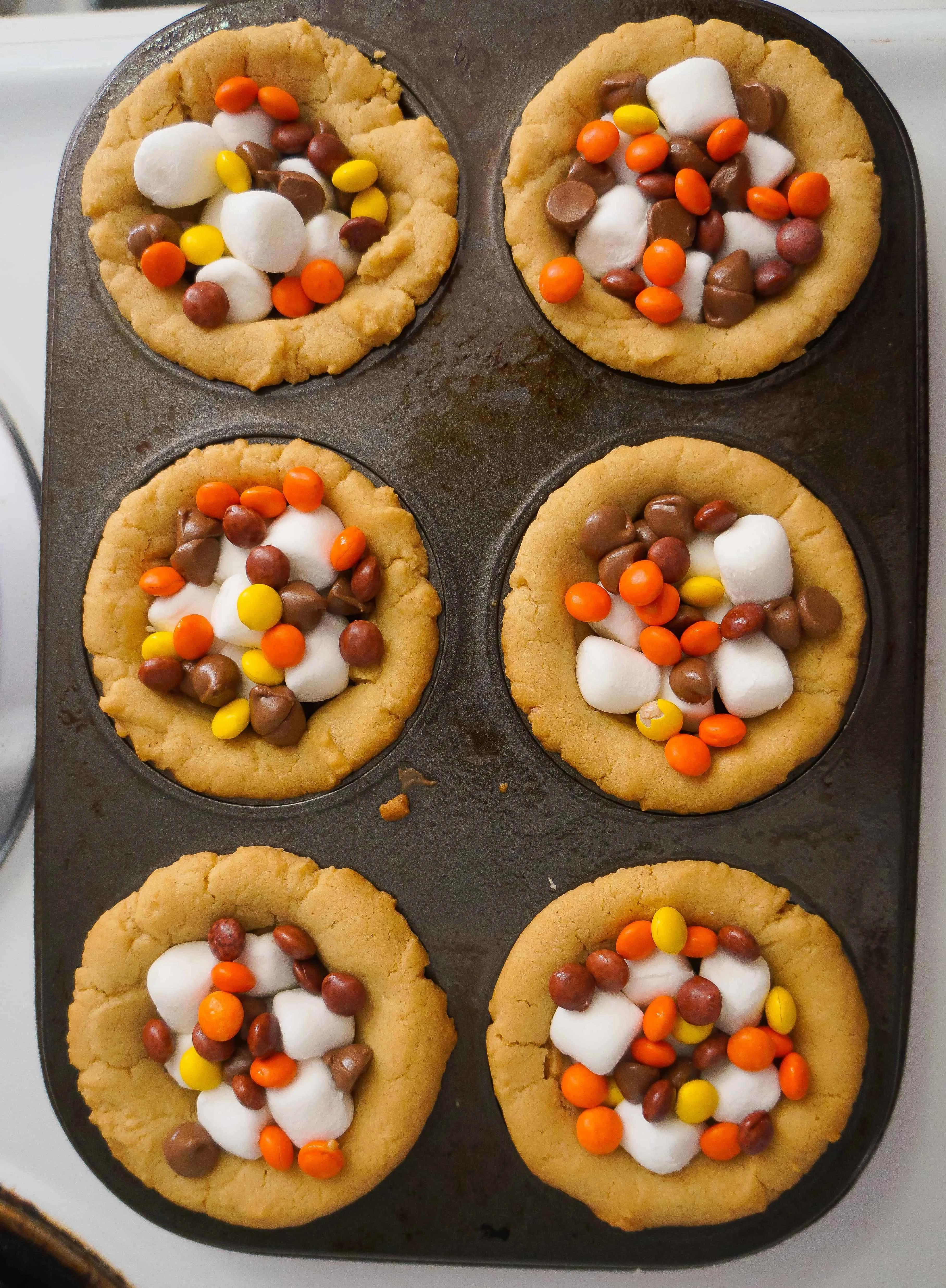 peanut butter cookie cups with mini Reese's pieces