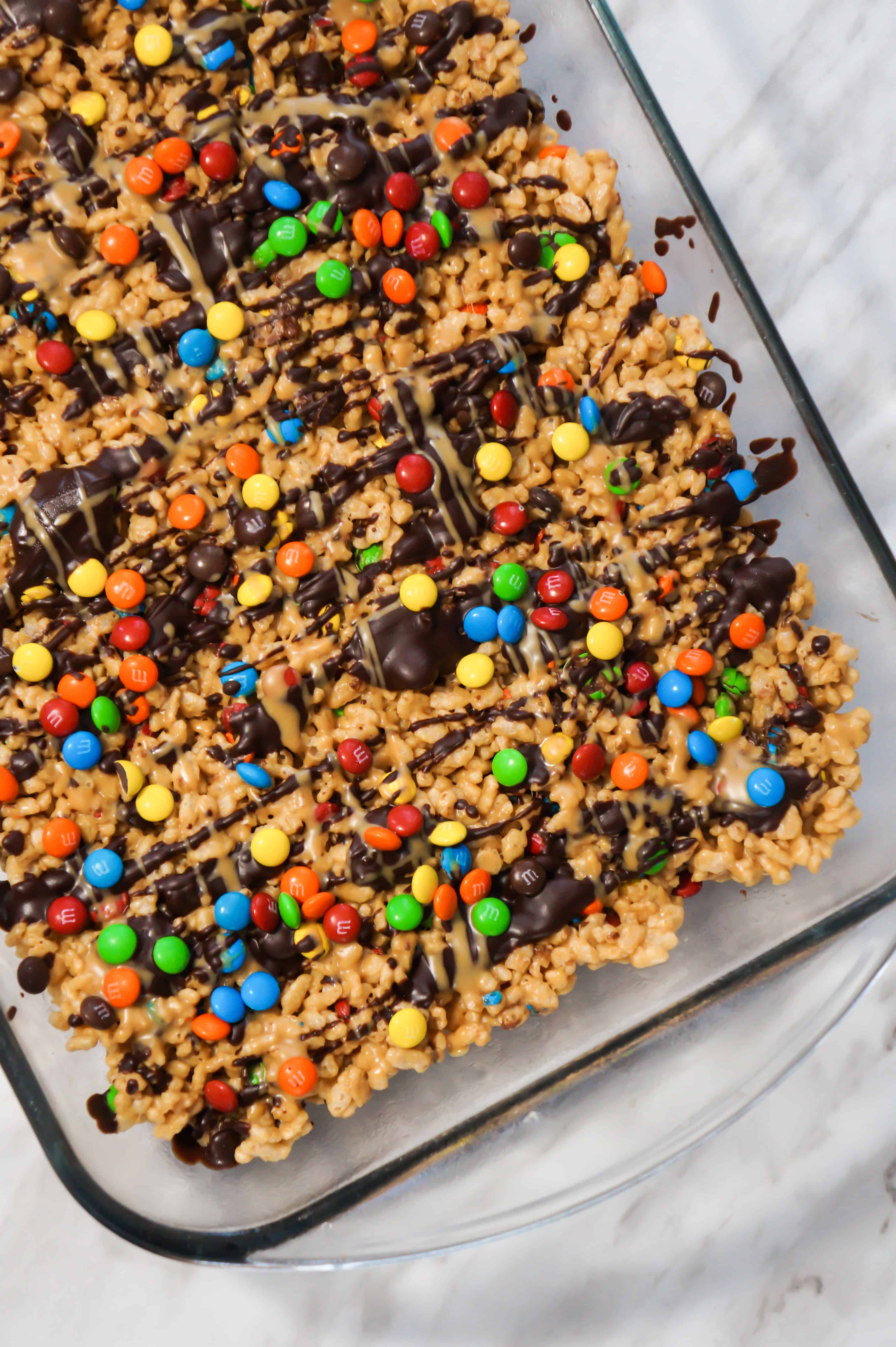 Peanut Butter Rice Krispie Treats. Easy chocolate peanut butter dessert recipe. Rice Krispie squares loaded with M&Ms.