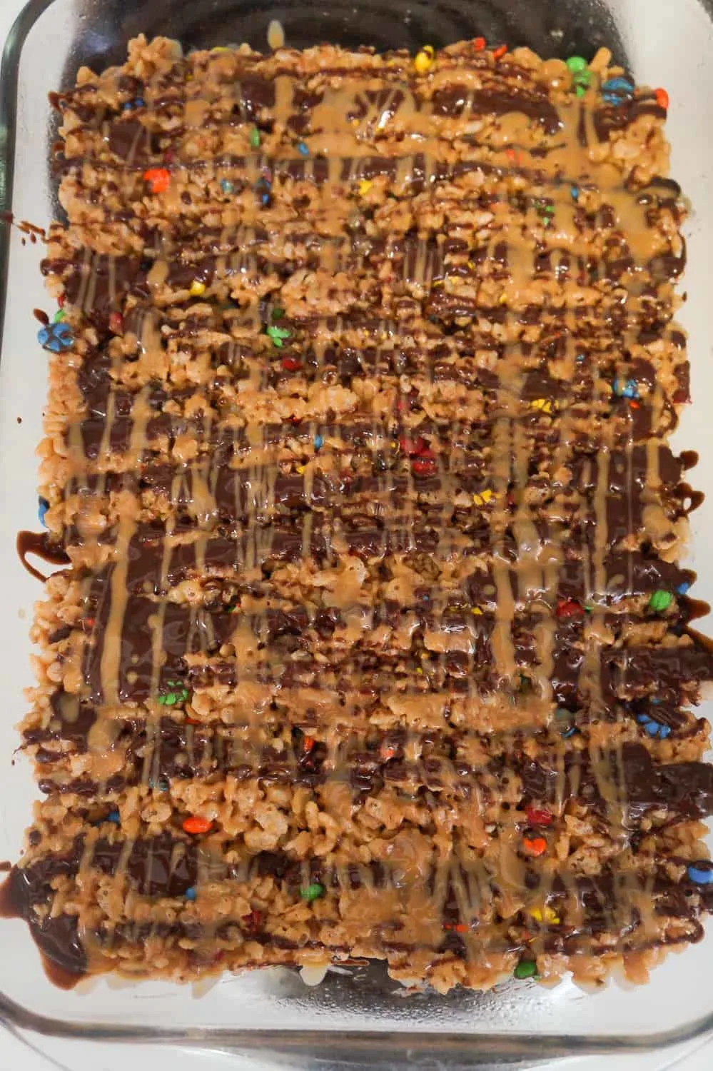 melted peanut butter and chocolate drizzled over rice krispie treats
