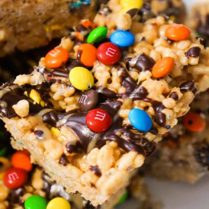 Peanut Butter Rice Krispie Treats. Easy chocolate peanut butter dessert recipe. Rice Krispie squares loaded with M&Ms.