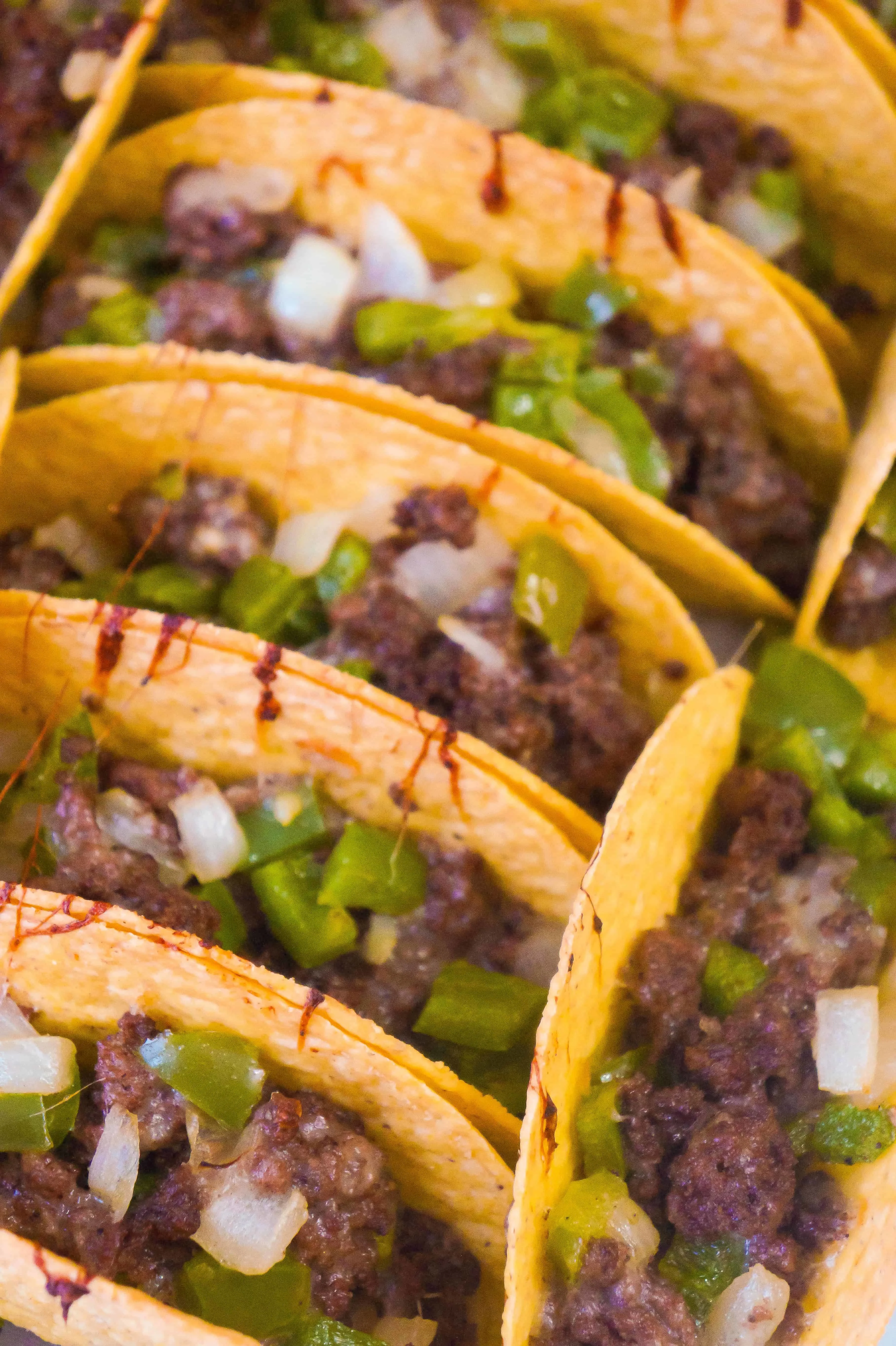 Philly Cheese Steak Ground Beef Tacos are loaded with onions, green peppers and mozzarella cheese.
