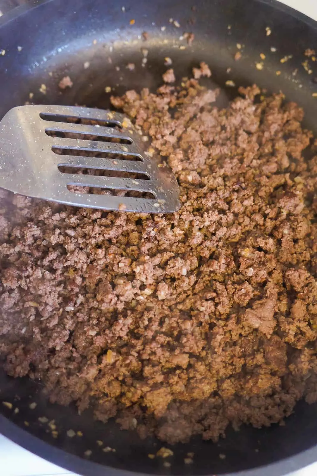 cooked ground beef in frying pan