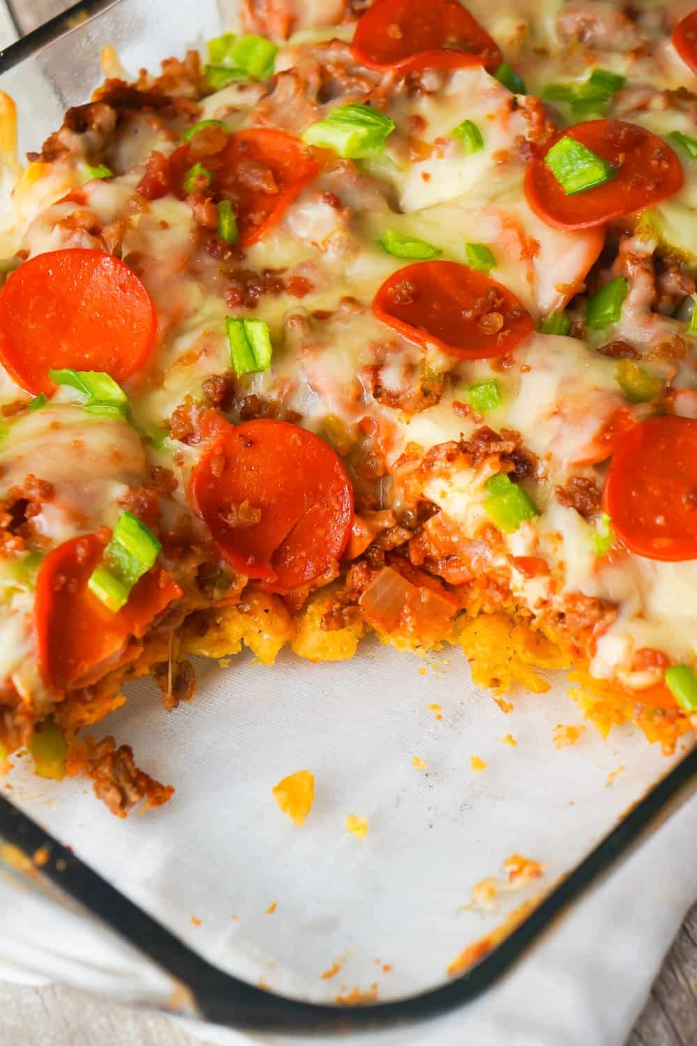 Pizza Frito Pie is an easy ground beef dinner recipe. This fun twist on the classic Frito pie is loaded with pepperoni, green peppers and bacon.