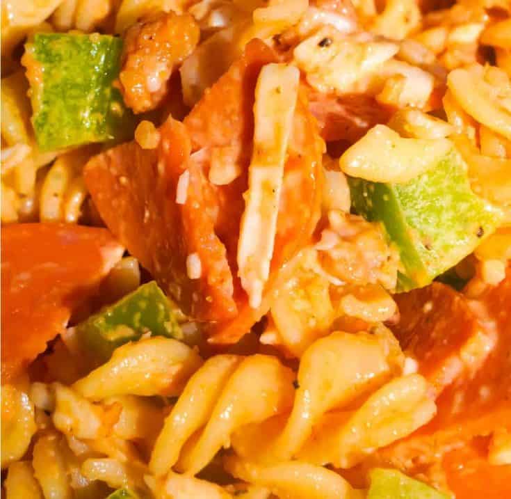 Pizza Pasta Salad is the perfect summer side dish. This pasta salad is loaded with pepperoni, bacon, green peppers and mozzarella cheese.