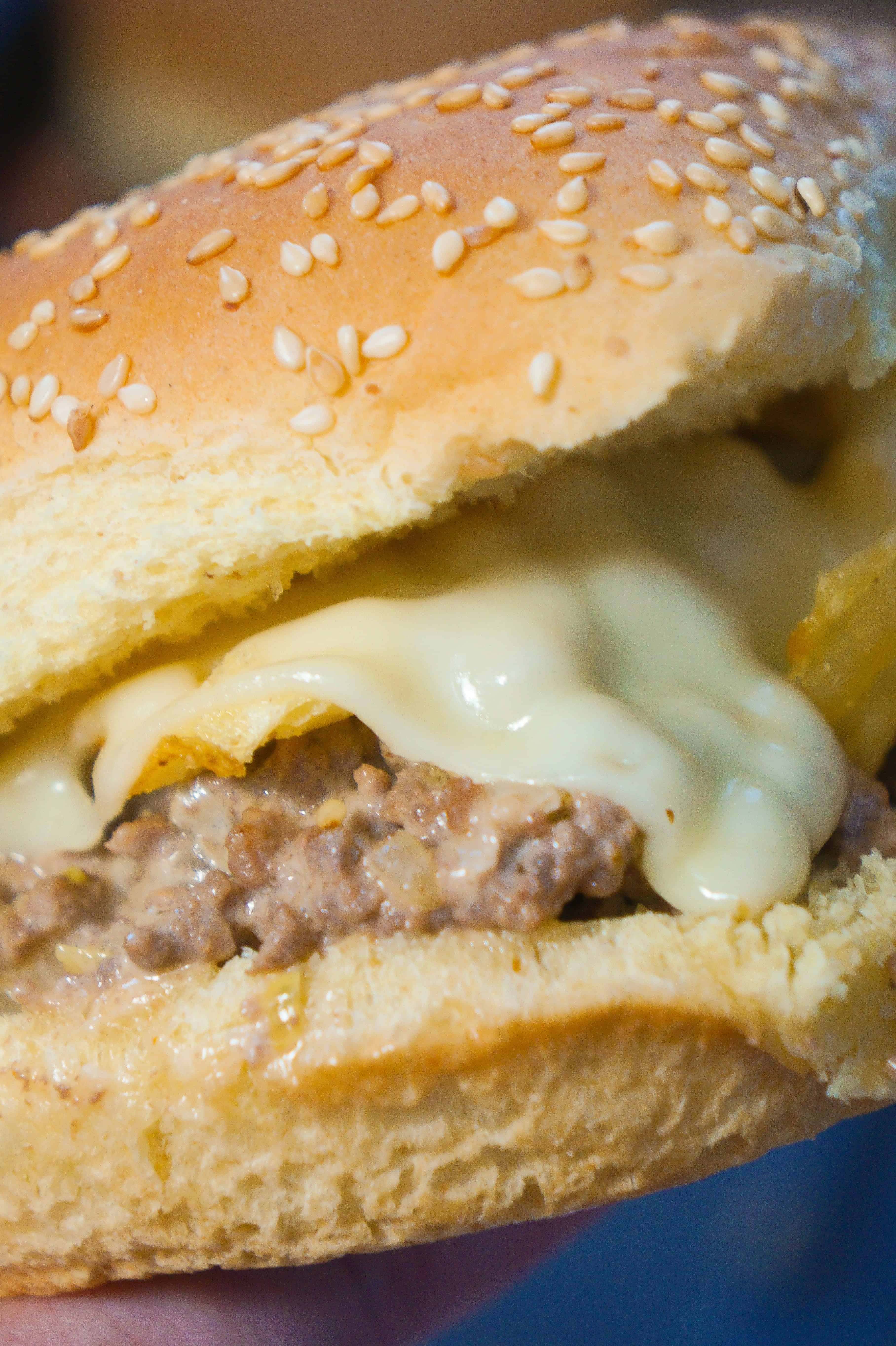 Loose Meat Sandwiches topped with potato chips and Swiss Cheese.