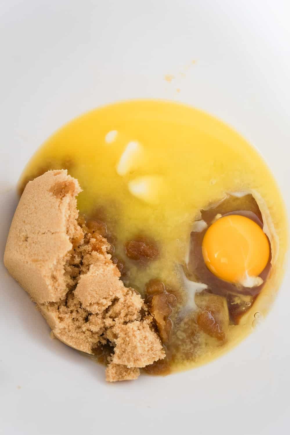 brown sugar, melted butter and an egg in a mixing bowl