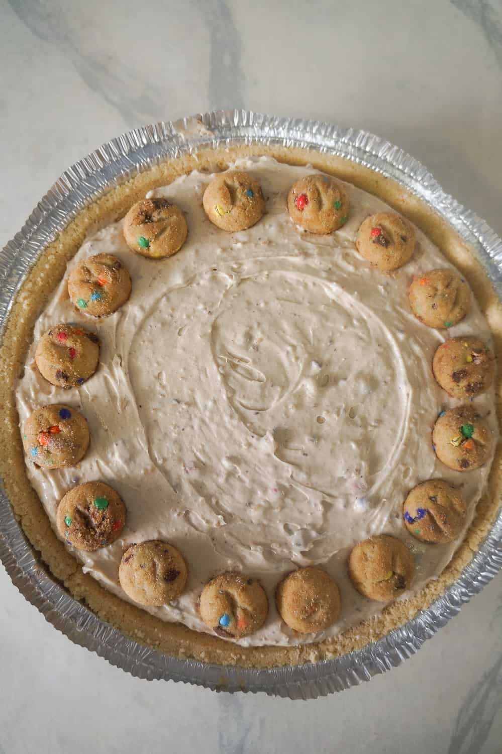 mini rainbow chips ahoy cookies on top of no bake cheesecake
