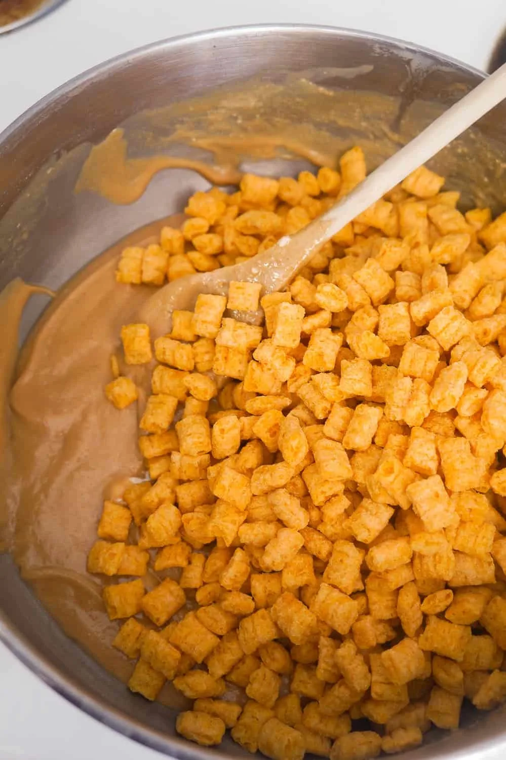 captain crunch cereal in melted peanut butter marshmallow mixture