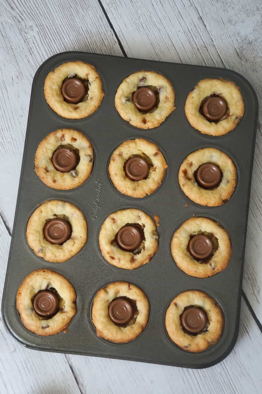 Rolo Sugar Cookie Cups are an easy dessert recipe using Betty Crocker Sugar Cookie Mix. These delicious cookies are baked in mini muffin tins and loaded with Skor bits, mini chocolate chips and Rolo chocolates.