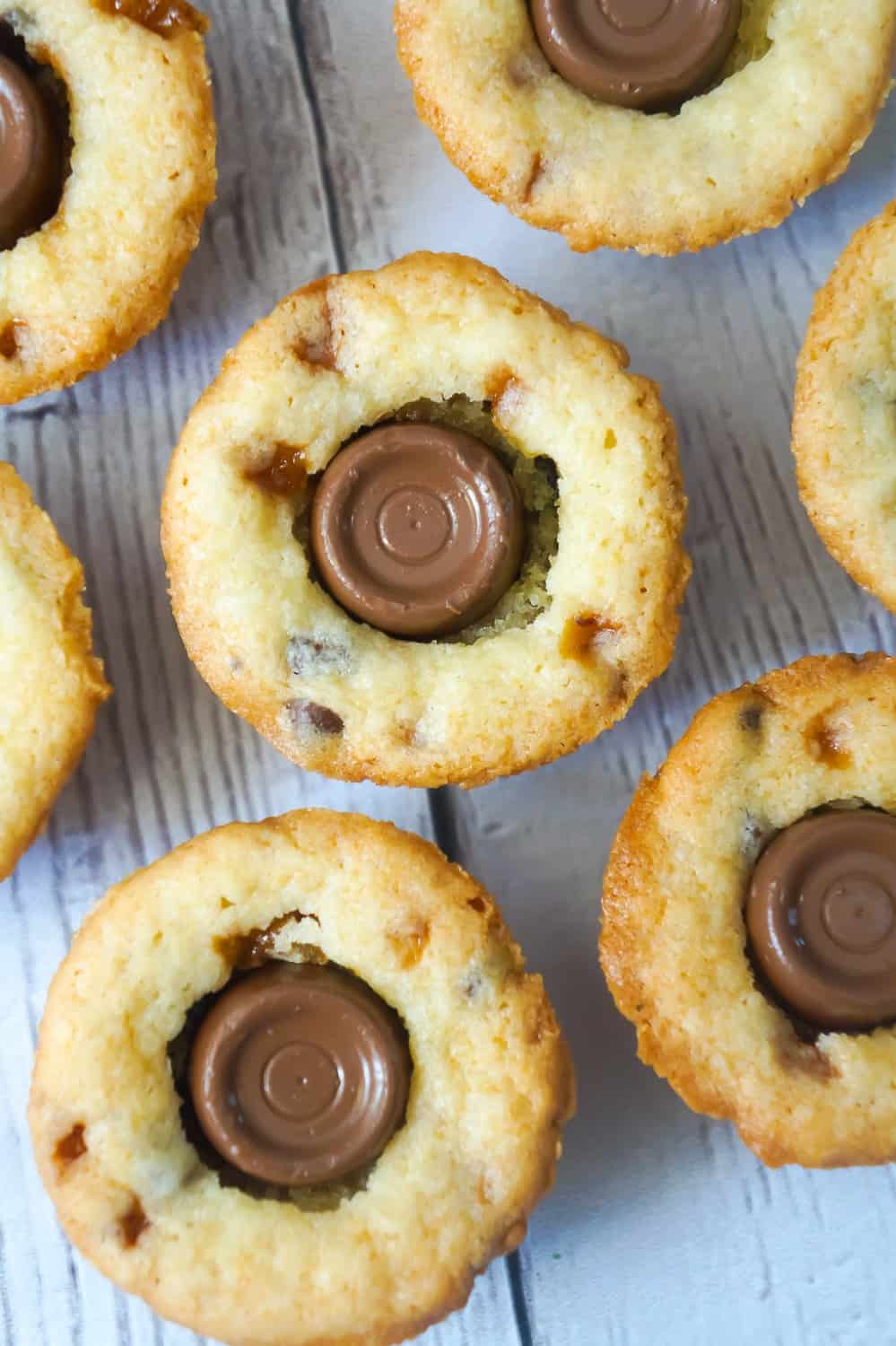 Rolo Sugar Cookie Cups are an easy dessert recipe using Betty Crocker Sugar Cookie Mix. These delicious cookies are baked in mini muffin tins and loaded with Skor bits, mini chocolate chips and Rolo chocolates.