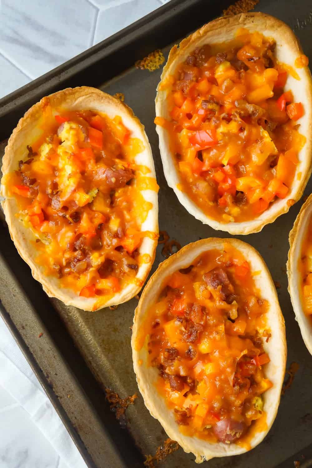 Sausage and Egg Breakfast Tacos are a fun and easy breakfast recipe. These breakfast tacos are made in Old El Paso tortilla bowls and loaded with eggs, maple breakfast sausage, cheddar cheese, sweet bell peppers and bacon.