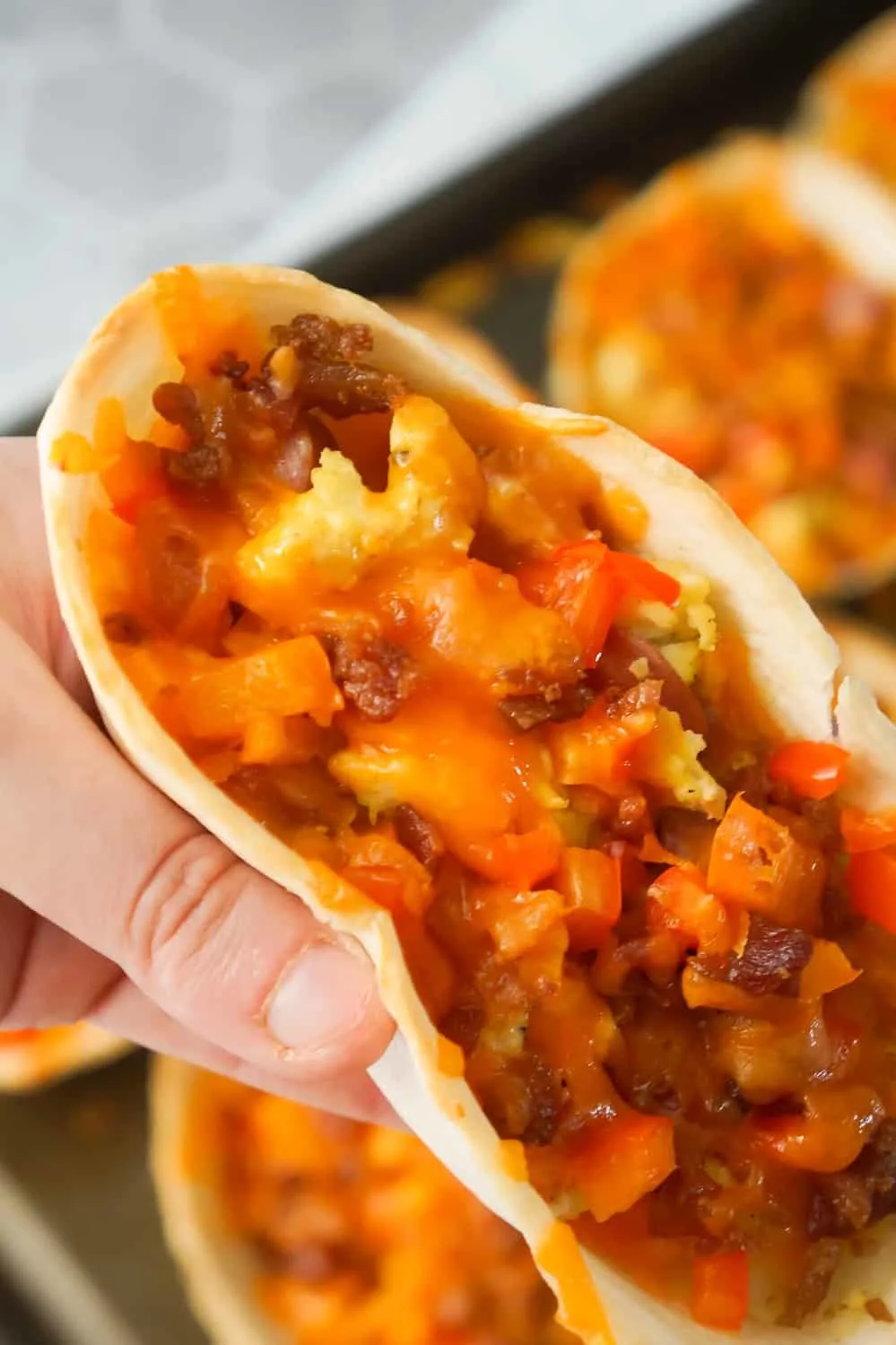 Sausage and Egg Breakfast Tacos are a fun and easy breakfast recipe. These breakfast tacos are made in Old El Paso tortilla bowls and loaded with eggs, maple breakfast sausage, cheddar cheese, sweet bell peppers and bacon.
