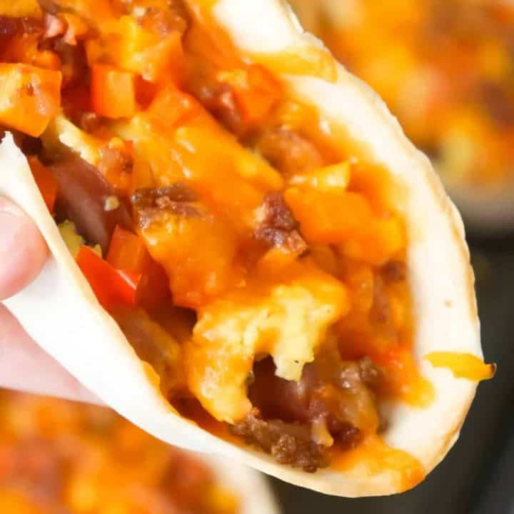 Sausage and Egg Breakfast Tacos are a fun and easy breakfast recipe. These breakfast tacos are made in Old El Paso tortilla bowls and loaded with eggs, maple breakfast sausage, cheddar cheese, sweet bell peppers and bacon.