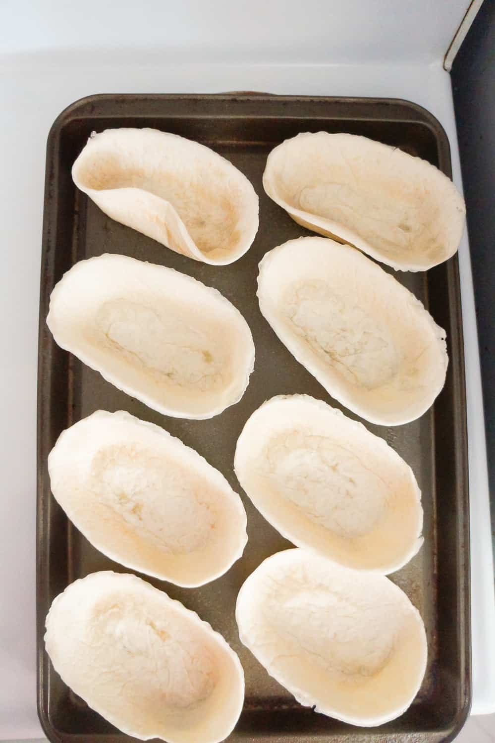 tortilla bowls on a baking sheet