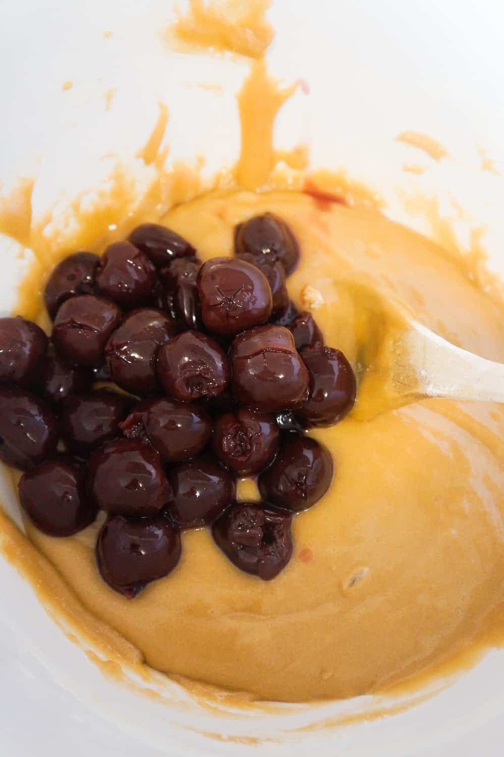blondie batter with sour cherries added in a mixing bowl