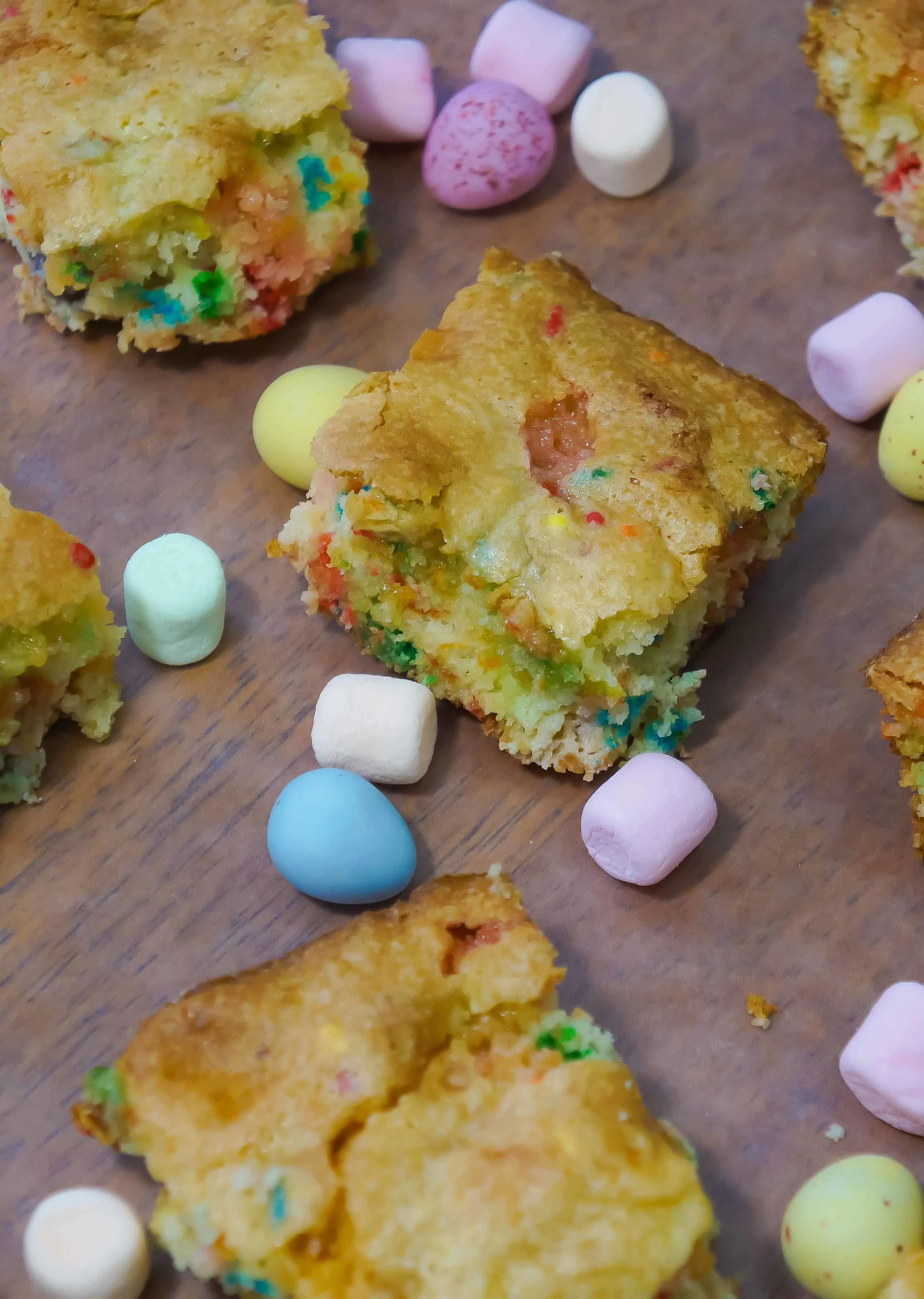 Springtime Funfetti Bars with Mini Eggs are any easy cake mix cookie bar recipe perfect for Easter. These delicious cookie bars are made with confetti cake mix and loaded with colourful mini marshmallows and mini eggs.