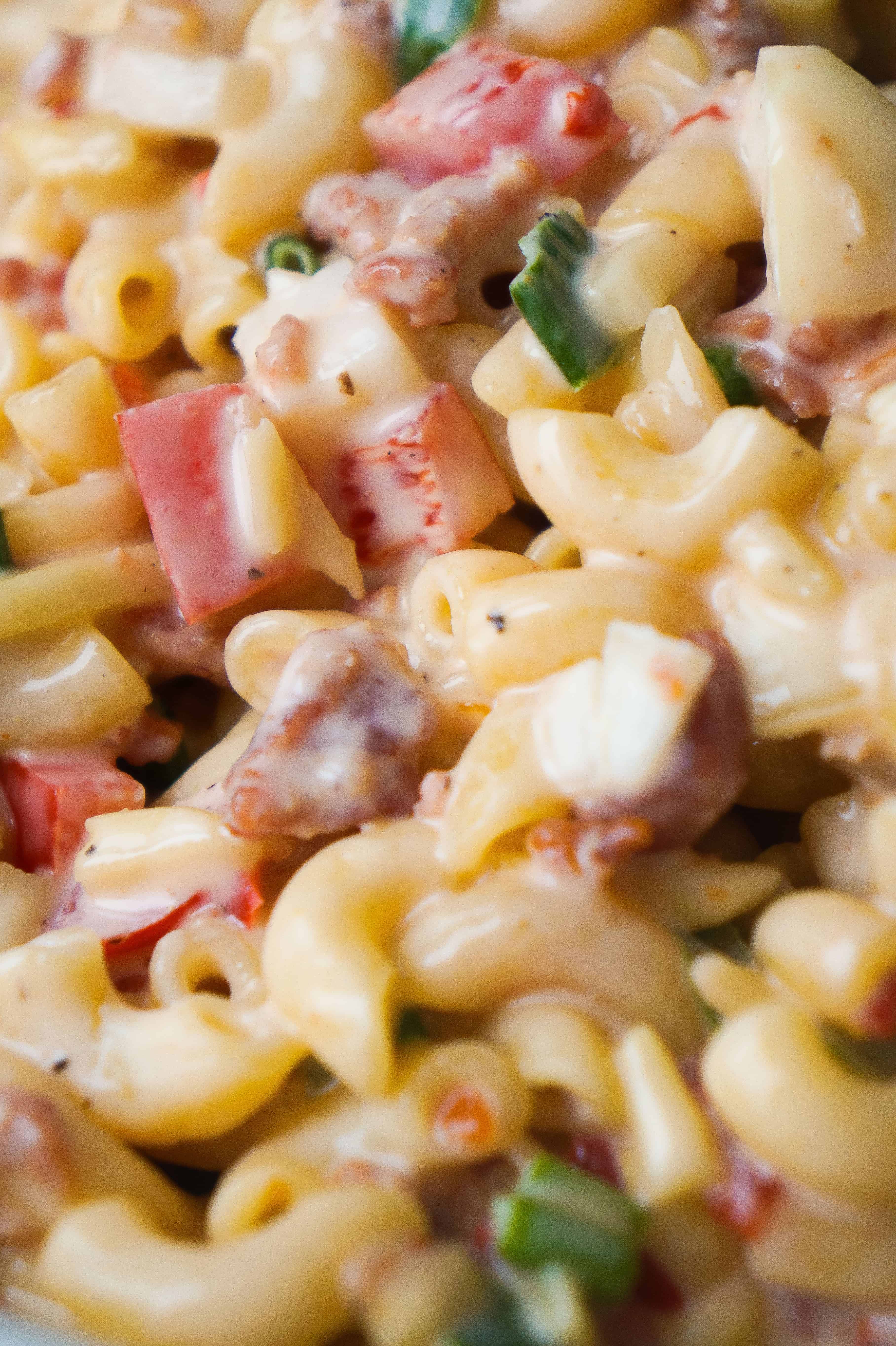 Sweet Chili Bacon Pasta Salad is the perfect side dish for potluck parties. This cold macaroni salad loaded with bacon, red peppers and green onions is tossed in a sweet and spicy sauce. This is an easy BBQ side dish recipe.