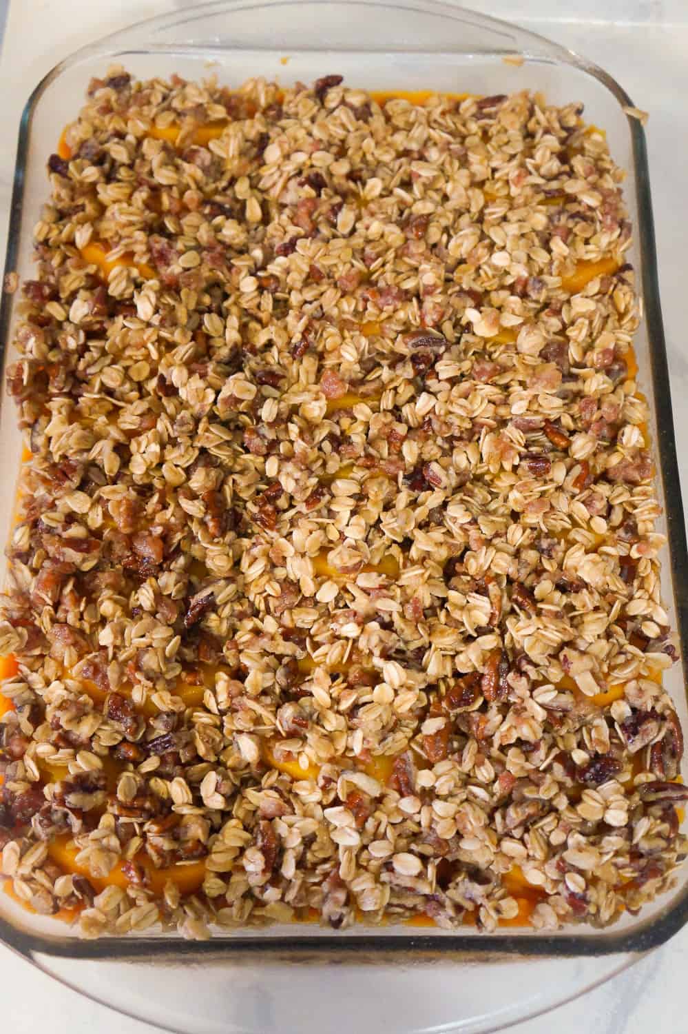 Sweet Potato Casserole with Peaches, Pecans & Bacon is the perfect side dish for a holiday dinner. Creamy mashed sweet potatoes are topped with sliced peaches and an oat crumble with pecans and bacon.