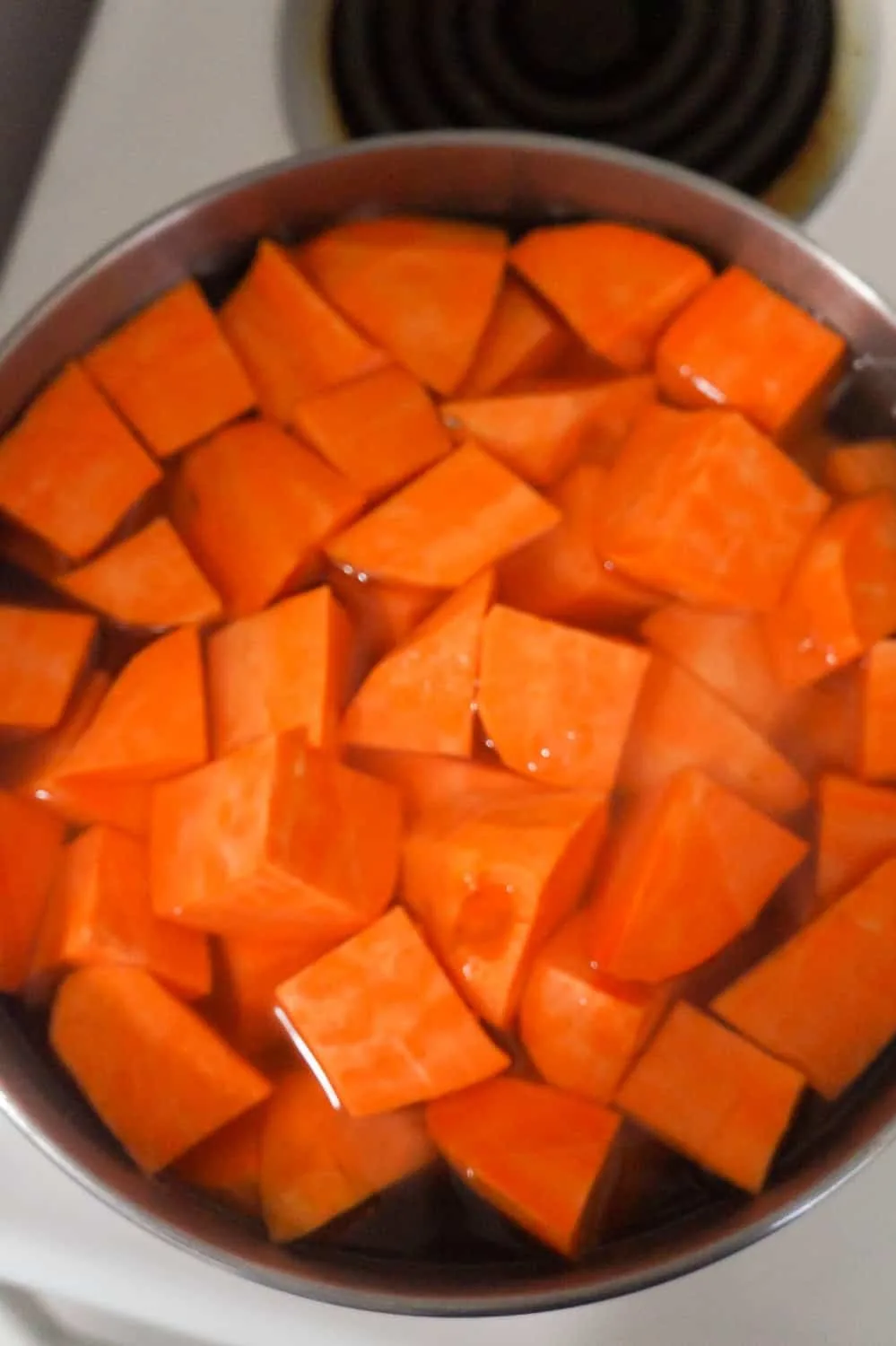 sweet potato chunks in a pot of water