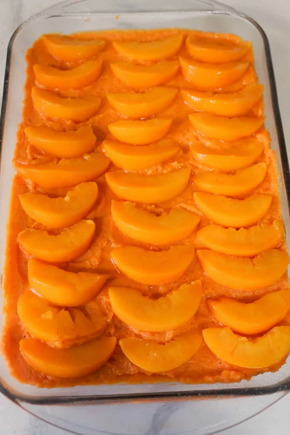 peach slices on top of sweet potato casserole