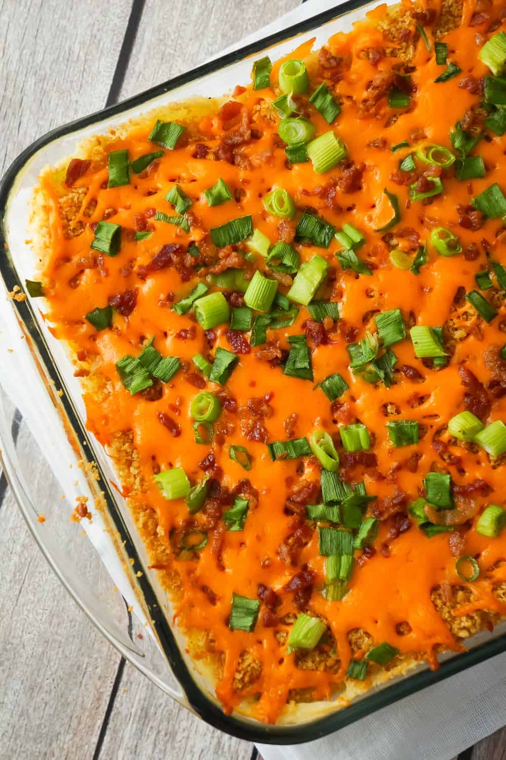 Loaded Mashed Potato Casserole is a hearty side dish recipe perfect for holiday dinners. This mashed potato casserole is loaded with cheddar cheese, bacon, onions and crushed Ritz crackers.