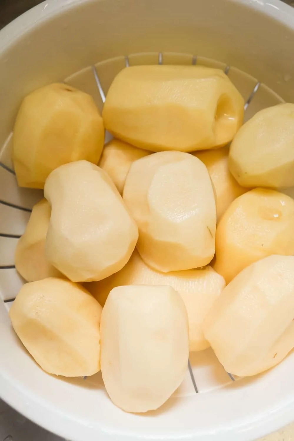 peeled potatoes in a strainer