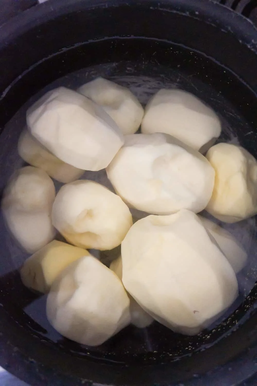 peeled potatoes in a pot of water