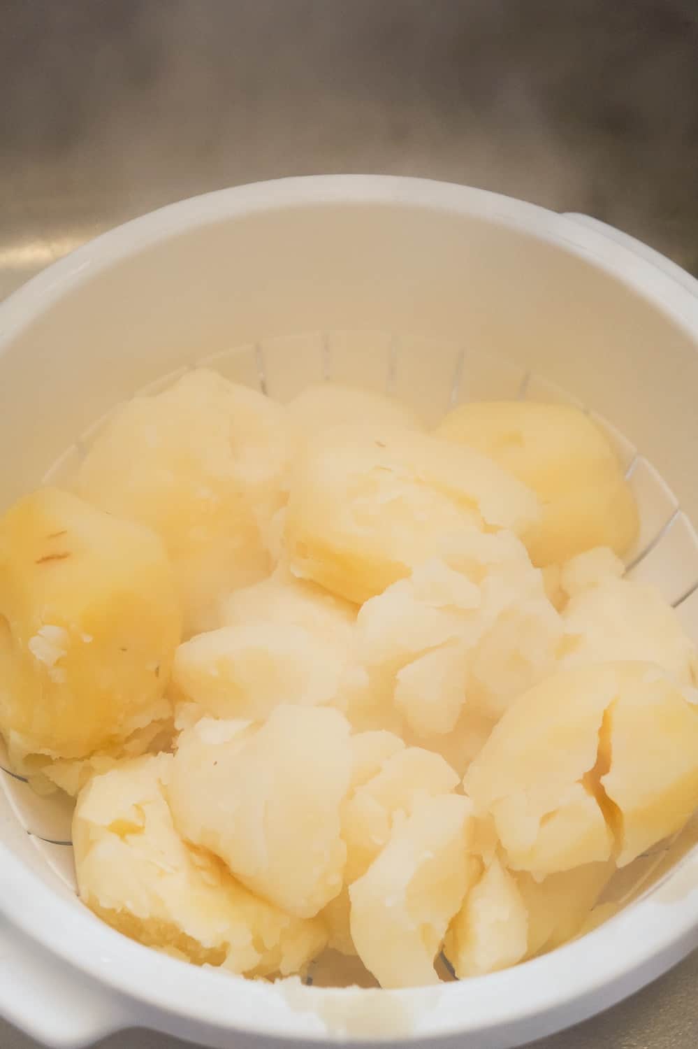 cooked potatoes in strainer