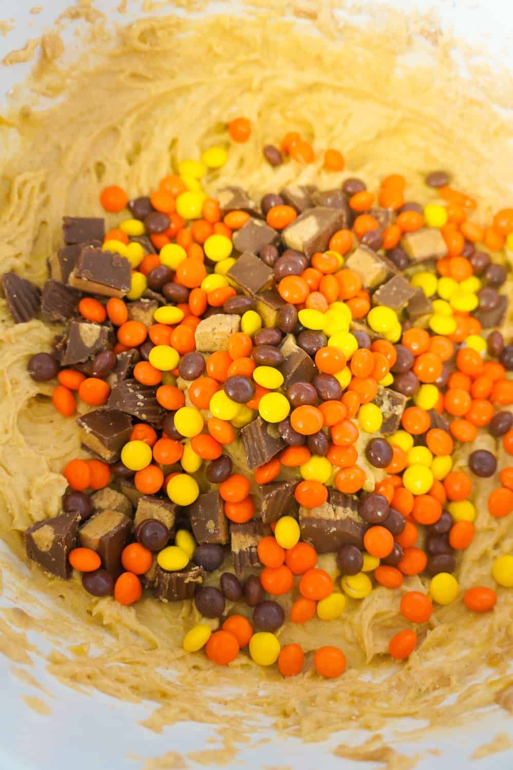 mini Reese's Pieces in peanut butter banana cake batter